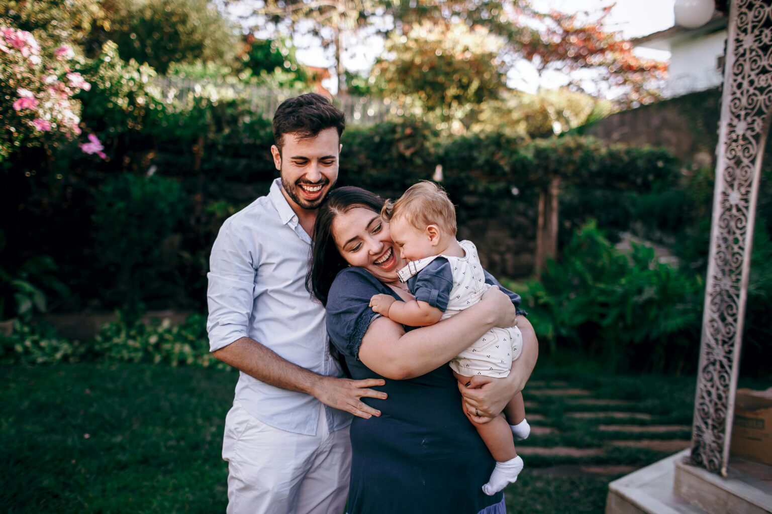 A joyful family moment in a lush, sunny garden setting.